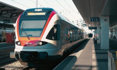 a train pulling into a train station next to a platform