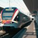 a train pulling into a train station next to a platform