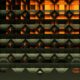 Abstract geometric pattern with glowing orange and dark metallic shapes.